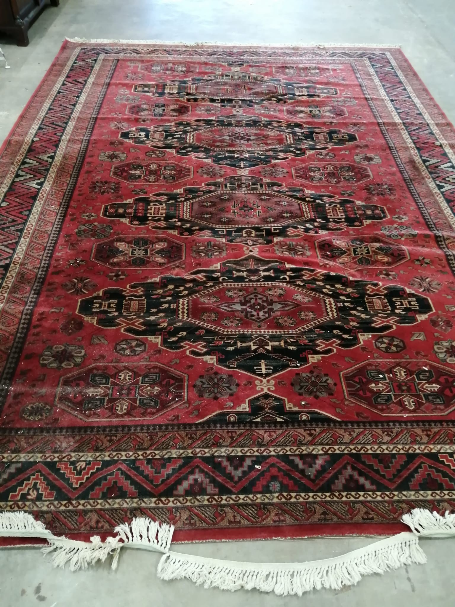 A Caucasian style red ground carpet, 414 x 298cm